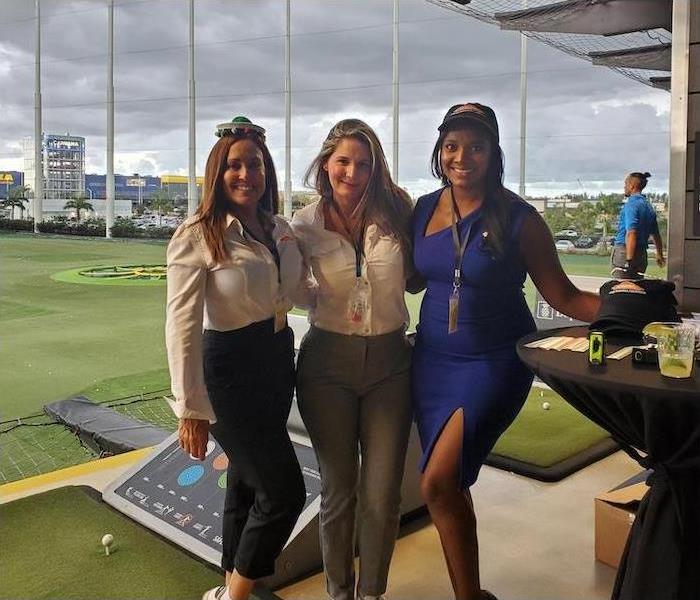 three females at a golf  facality