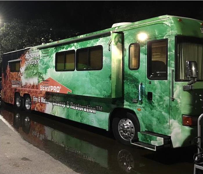 SERVPRO bus on a street at night