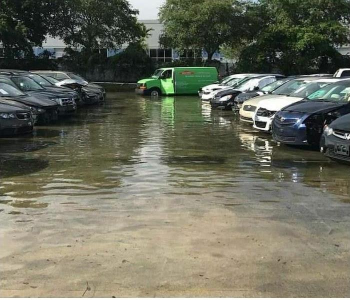 Flooded parking lot with a SERVPRO van in the back